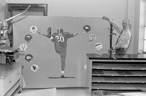 [Carter with a football painting]