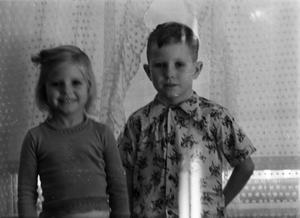 [Photograph of Carol and Tim Williams in front of a window, 2]