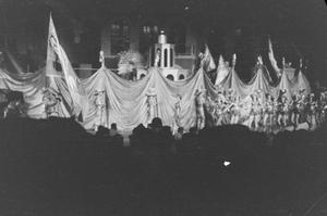 [Photograph of a stage performance with draped fabric]