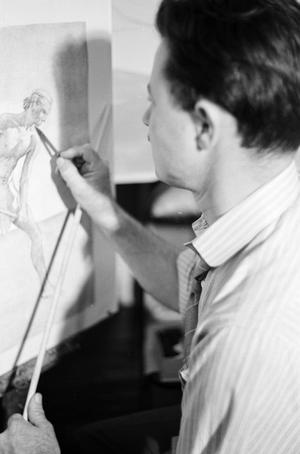 [Photograph of a man drawing]