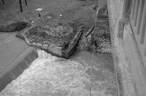 [Photograph of water under a bridge near the Tarrant County Courthouse]