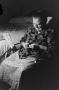 Photograph: [Photograph of an old woman sitting in a bedroom, 2]