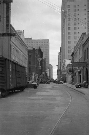 [Photograph of a street lined with tall buildings]