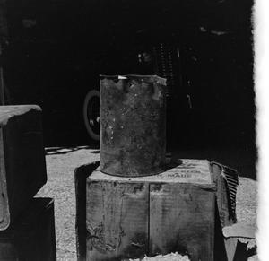 [Photograph of a bucket on a box]