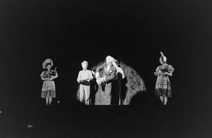 [Photograph of individuals performing on stage]