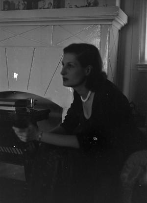 [Photograph of Doris Stiles Williams sitting by a fireplace, 2]