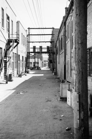 [Photograph of an alleyway between brick buildings]