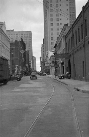 [Photograph of a street lined with tall buildings, 2]