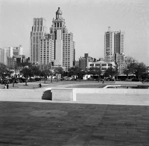 [Photograph of tall buildings and a city park]