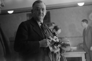 [Photograph of a man holding a camera]