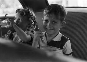 [Photograph of Carol and Tim Williams in the back of a car]