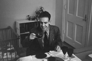 [Photograph of a man holding up a teacup]