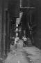 Photograph: [Photograph of a child in an alley, 2]