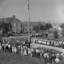 Photograph: [Large crowd gathered around flag pole]