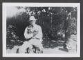Photograph: [Photograph of a man holding two cats]