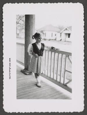 [Photograph of Carol Williams posing on a front porch]