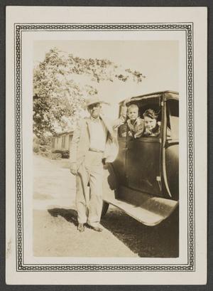 [Man and two children with an automobile]