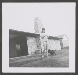 [Photograph of Pam Williams in the backyard with Angus]