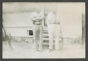 [Byrd Williams Jr. standing outside with his son John]