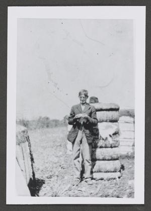 [Photograph of a man standing in a field]