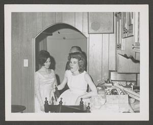 [Photograph of two women in a kitchen at a Christmas celebration]