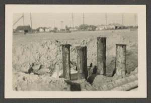 [Construction site with posts in the ground]