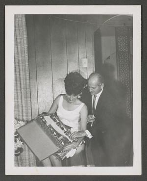 [Doris and Byrd Williams III opening a Christmas gift]