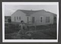 Photograph: [Photograph of Pam Williams posing in a backyard]