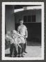 Photograph: [Photograph of a boy with a toddler-aged boy and girl]