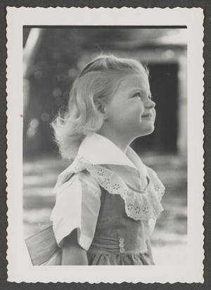 [Photograph of young Carol Williams in a dress with a large collar]