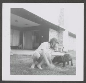 [Photograph of Pam Williams in a backyard with Angus]