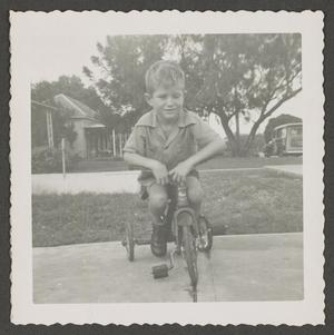[Tim on a tricycle]