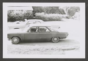[Photograph of three parked automobiles]