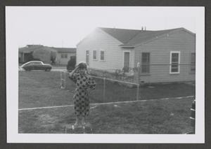 [Photograph of Pam Williams standing in a backyard]