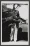 Photograph: [George Stiles next to a biplane]