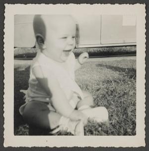 [Photograph of baby Paul sitting in the grass]