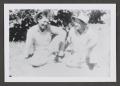 Photograph: [An unknown man and Albert sitting outside in the grass]
