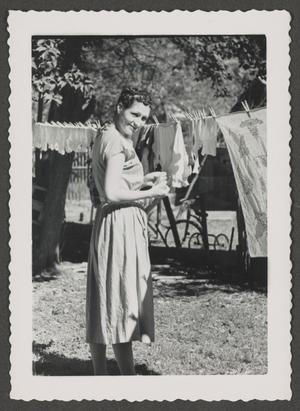 [Photograph of Doris Stiles Williams posing by a clothesline]