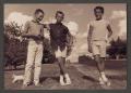 Primary view of [Photograph of three boys posing in a yard]