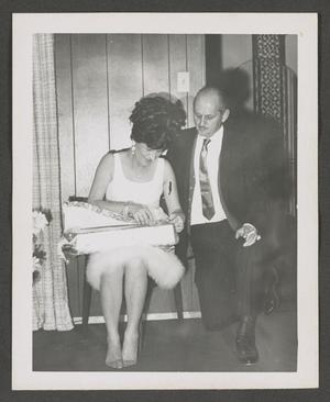 [Photograph of Doris and Byrd Williams III opening a Christmas gift]