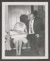 Photograph: [Photograph of Doris and Byrd Williams III opening a Christmas gift]