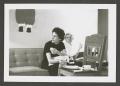 Photograph: [Photograph of Doris Williams and Sarah eating on a couch]