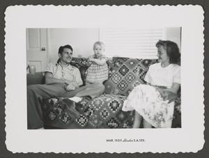 [Photograph of baby Pam Williams with a man and a woman]