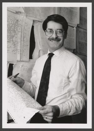 [Photograph of David Finfrock holding a weather map]