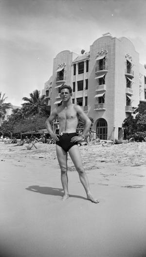 [Charles Williams in a swimsuit at a beach]