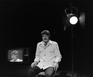 [Photograph of David Finfrock posing for a portrait by a television, 5]