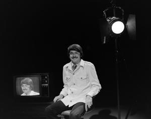 [Photograph of David Finfrock posing for a portrait by a television, 4]