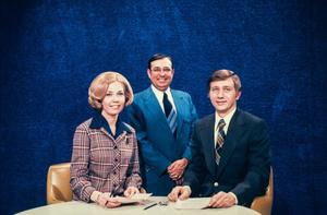 [Photograph of Sharon Noble, Ron Godby, and Lee Elsesser sitting at a table]