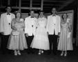 Photograph: [Bride and groom posing with two other couples]