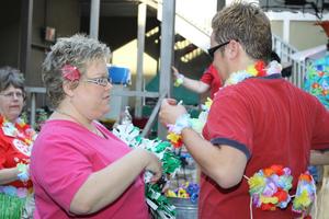 [Helpers wearing luau accessories at the second pit-stop]